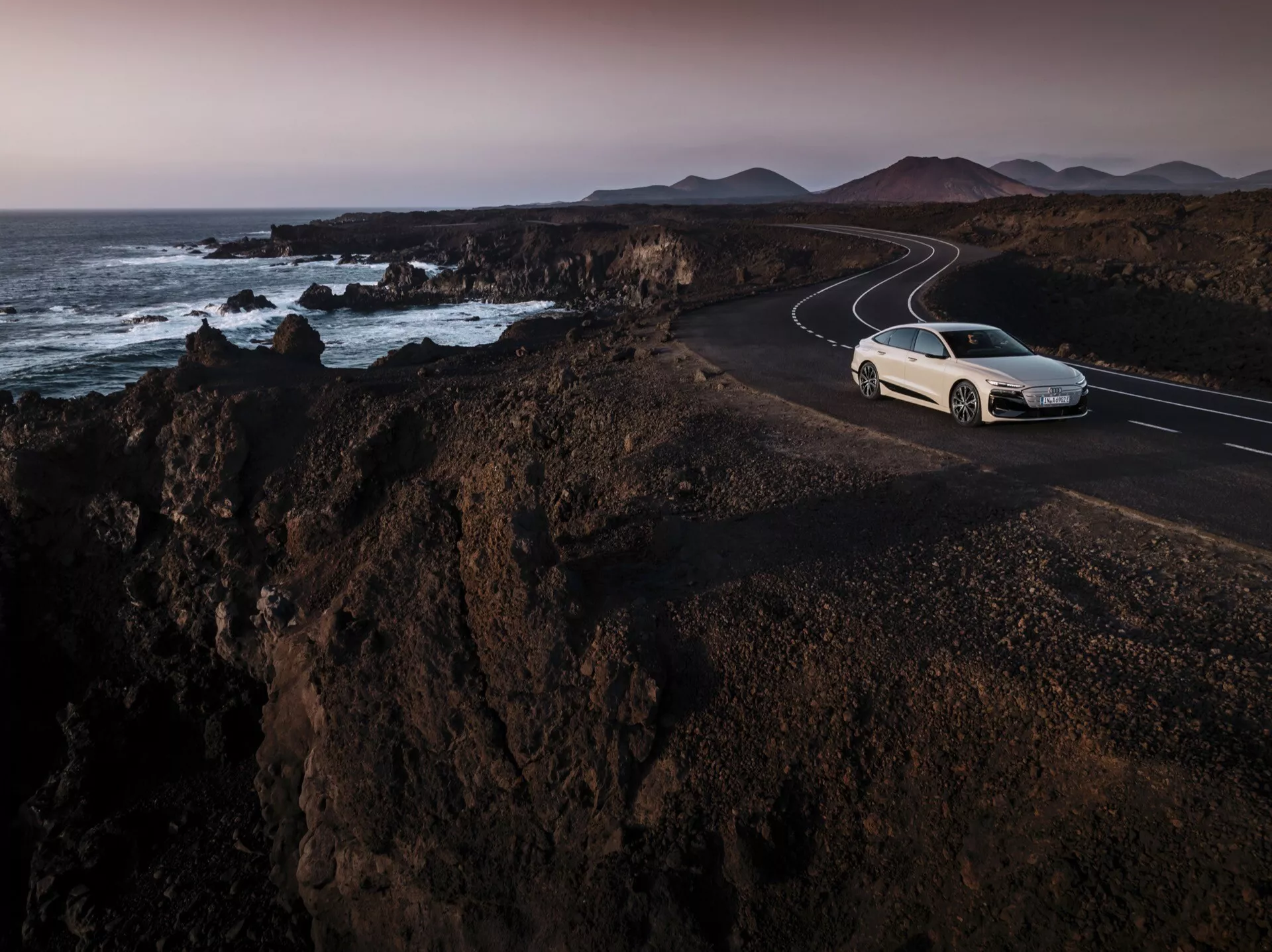 Audi A6 e-tron 2024 - Berline électrique élégante avec aérodynamique avancée, technologie de pointe et design futuriste. Présenté en blanc glacier métallisé avec des phares LED distinctifs et un profil aérodynamique.