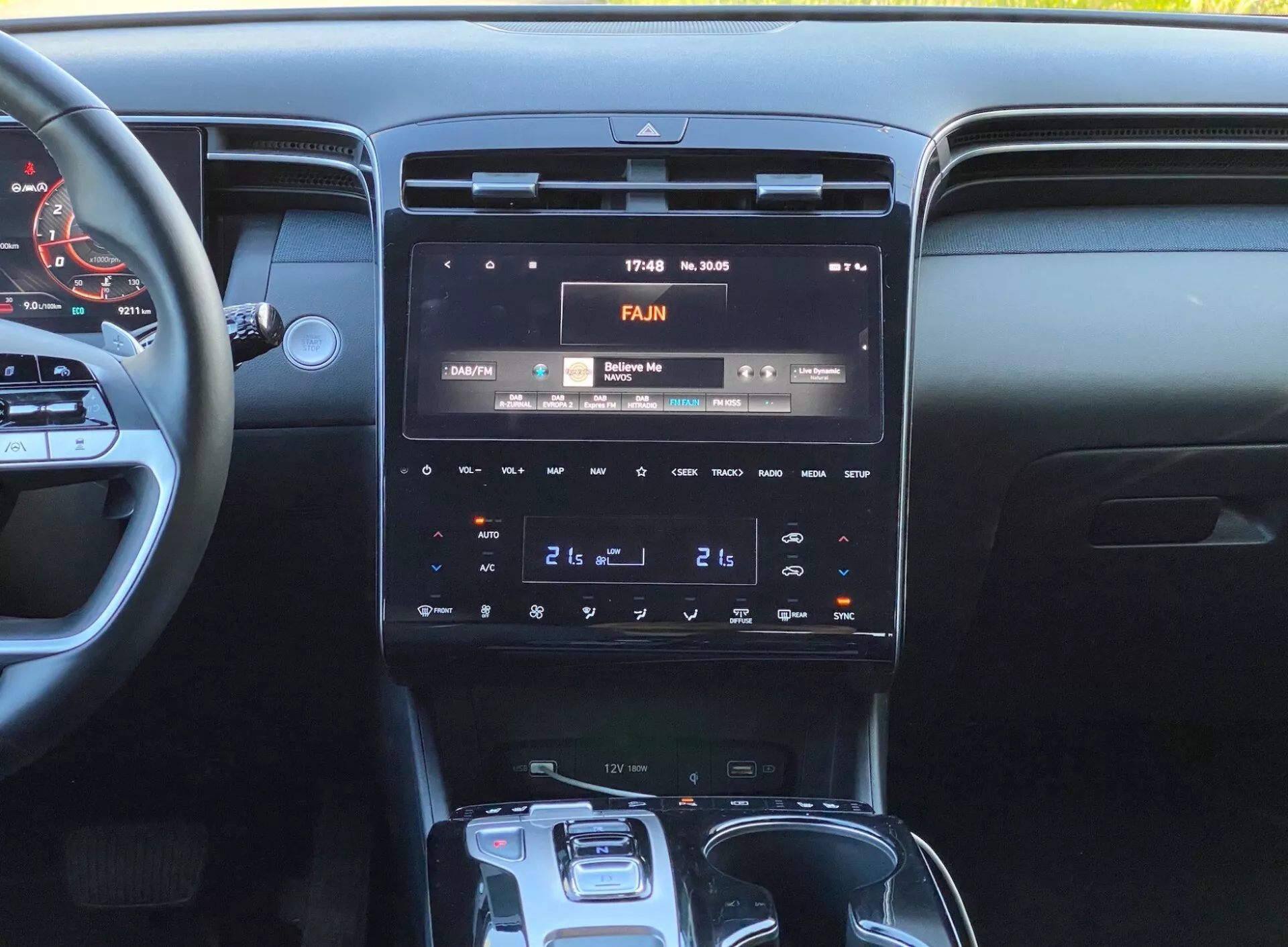 Image de l'intérieur de la Hyundai Tucson 2020, se concentrant sur la console centrale avec un écran d'infodivertissement haute résolution affichant 17:43 et 30°C, un panneau de contrôle climatique à double zone et un sélecteur de boîte de vitesses automatique.