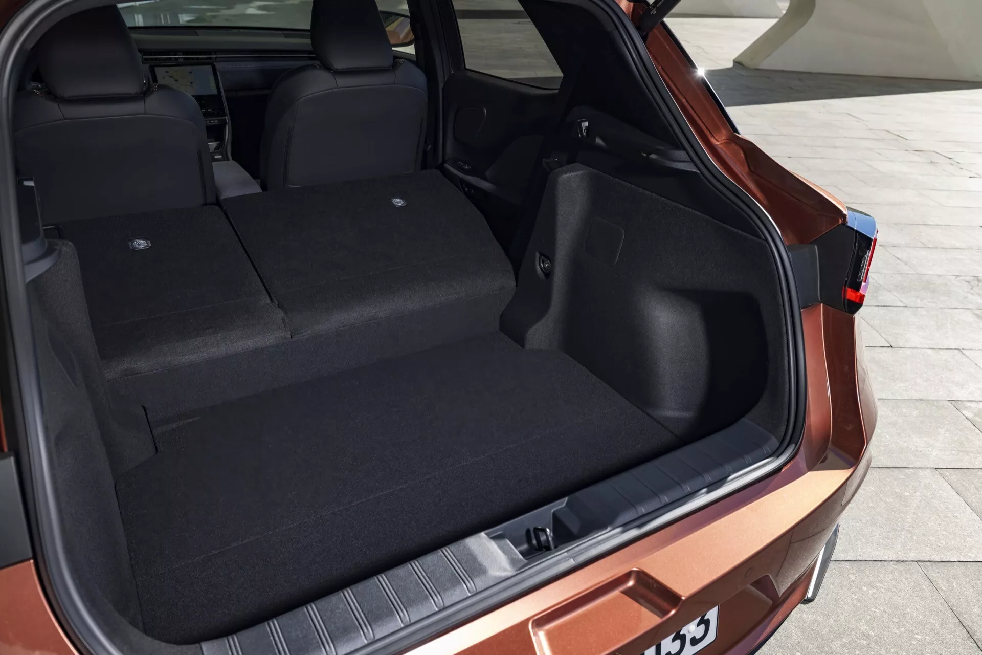 Lexus LBX 1ère génération 2024 présentant l'espace de chargement arrière depuis une perspective arrière des trois-quarts, mettant en évidence la capacité importante du coffre, la conception intérieure durable et les caractéristiques extérieures modernes sans présence humaine.