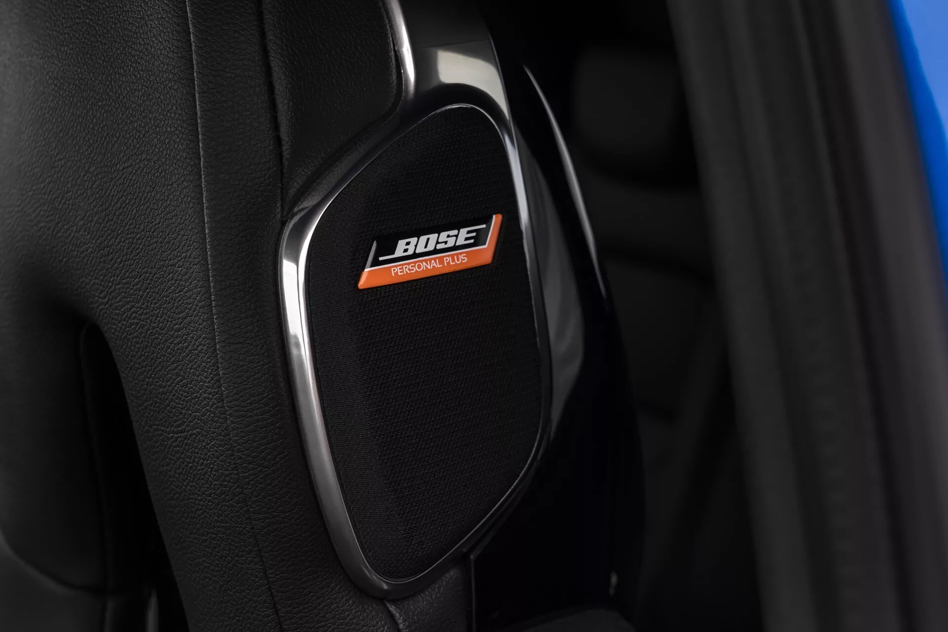 Vue rapprochée d'un couvercle de haut-parleur de marque BOSE de qualité supérieure dans un Nissan Juke 2019 (F16), mettant en lumière la technologie du système audio de haute qualité à l'intérieur d'une voiture de luxe.