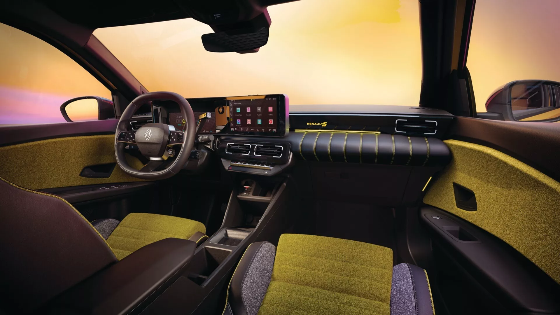 Vue intérieure du Renault R5 2024 depuis le point de vue du passager avant, mettant en évidence le volant multifonctions, le tableau de bord numérique, le grand écran tactile d'infodivertissement, et la conception élégante de la ventilation sur le tableau de bord avec éclairage d'ambiance.