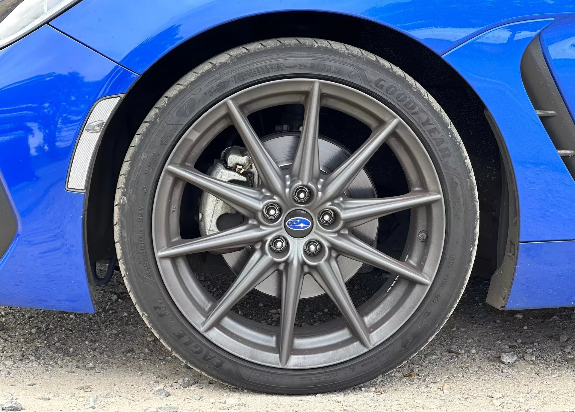 Image en gros plan de la Subaru BRZ 2023 montrant la roue en alliage avant et le pneu Continental, avec une carrosserie bleue vibrante visible