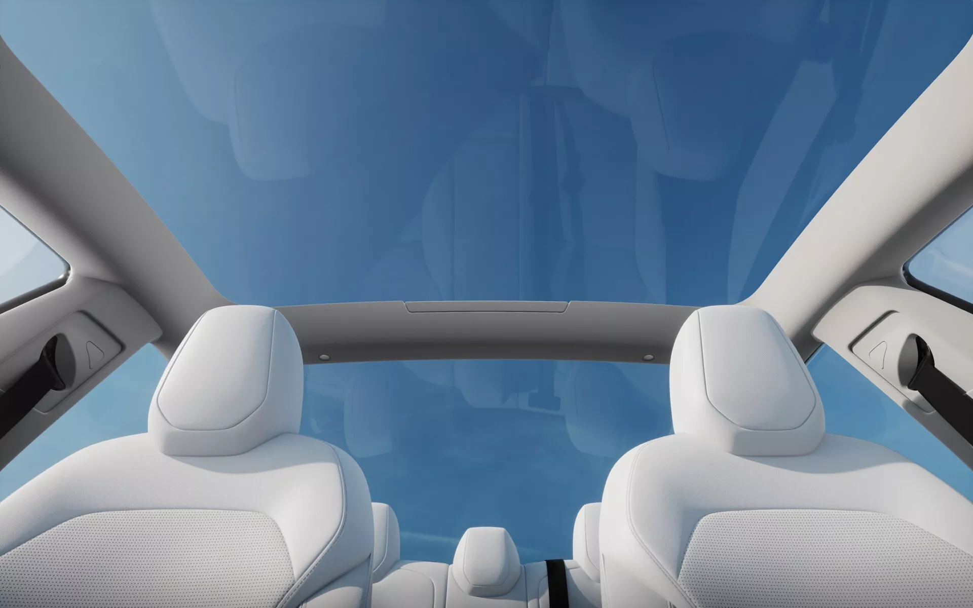 Vue intérieure de la Tesla Model 3 2023 (Facelift de 1ère Génération) mettant en lumière le toit panoramique et la partie supérieure des sièges avant en tissu blanc premium sous un ciel bleu