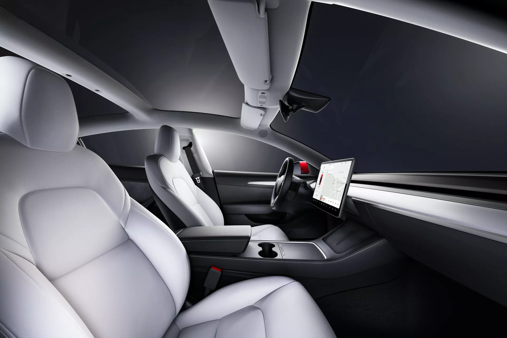 Vue intérieure de la Tesla Model 3 de 2019, Première Génération, mettant en avant les espaces du conducteur et du passager avant depuis une perspective arrière élevée. Les caractéristiques incluent des sièges en cuir contourés de couleur claire pour le confort et le soutien latéral, un écran tactile vertical proéminent pour les options multimédia et les paramètres du véhicule, un tableau de bord élégant et minimaliste avec des commandes intégrées, un volant à trois branches de style sportif avec des boutons multifonctions et une console centrale épurée avec des éléments de design minimaliste et des porte-gobelets.