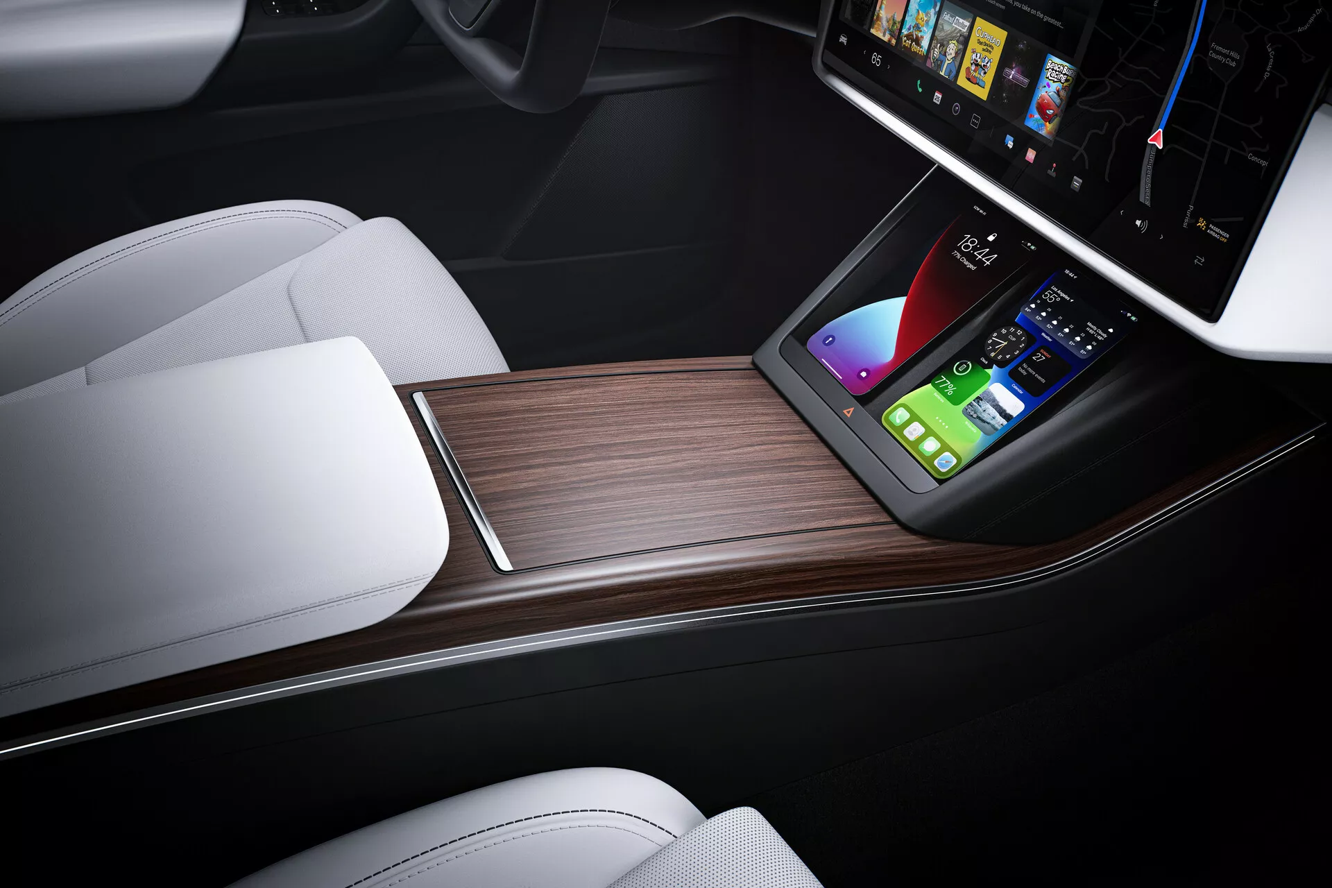 Vue rapprochée de l'intérieur d'une Tesla Model X 2021 (facelift de première génération) centrée sur la console centrale. Prise de vue d'en haut avec une légère inclinaison vers l'avant, le design élégant présente un grand écran tactile vertical affichant des options d'infodivertissement avancées telles que la navigation et le contrôle des médias. Sous l'écran tactile se trouve une station de charge sans fil pour smartphones, placée dans une console luxueuse avec des sièges en cuir blanc contrastant et un panneau foncé, complétée par une finition en grain de bois. Cette image représente l'ingénierie automobile moderne, les caractéristiques de voiture high-tech et les éléments de design de luxe.